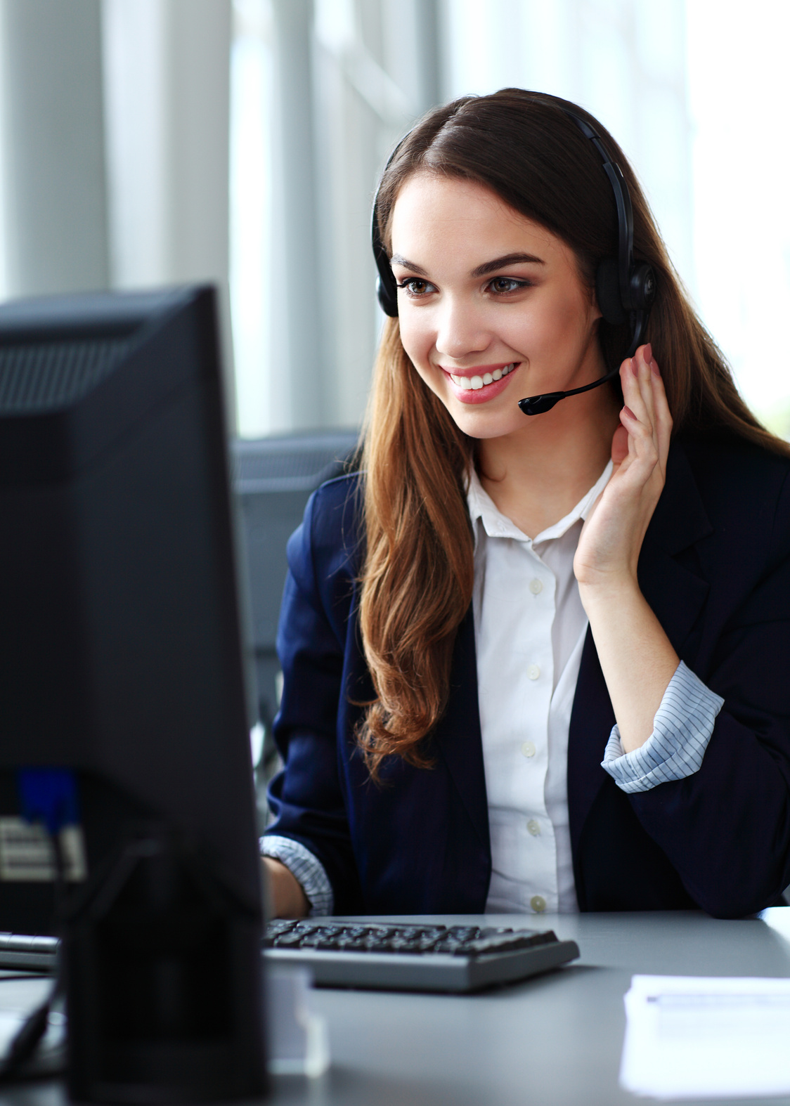 Female customer support operator with headset and smiling